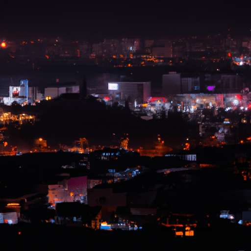 A panoramic shot of Eskişehir cityscape at night, with colorful lights illuminating the city