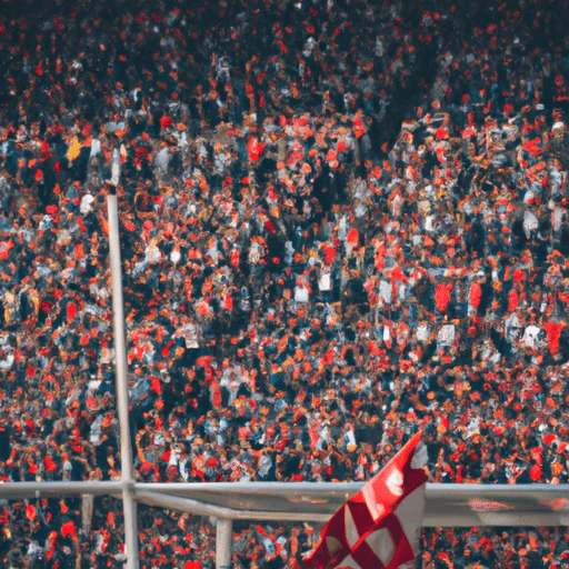 A panoramic shot of a crowded football stadium in Bursa, with fans passionately cheering for their team.